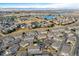 Community aerial view showcasing residential streetscapes, community pool, and surrounding landscape at 9461 Ashbury Cir # 104, Parker, CO 80134