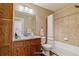 Bright bathroom featuring updated vanity, granite countertop, shower-tub combination, and ample storage space at 9461 Ashbury Cir # 104, Parker, CO 80134