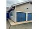 Two-car garages with blue doors and light gray siding, offering convenient parking and storage space at 9461 Ashbury Cir # 104, Parker, CO 80134