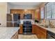 This kitchen features stainless steel appliances, wooden cabinets, and plenty of counter space at 9461 Ashbury Cir # 104, Parker, CO 80134