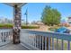 Outdoor patio with stone pillars and white railings overlooking landscaped common area with mature trees at 9461 Ashbury Cir # 104, Parker, CO 80134