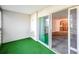 Enclosed balcony space with artificial turf and sliding door to the interior at 9340 E Center Ave # 8B, Denver, CO 80247