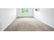 Spacious bedroom featuring neutral carpet, bright natural light, and large window at 9340 E Center Ave # 8B, Denver, CO 80247
