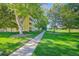 Well-maintained landscaping and walkway in front of a sunny, low-rise apartment building at 9340 E Center Ave # 8B, Denver, CO 80247