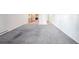 Spacious living area with neutral-toned carpeting, an open floorplan, and bright natural light at 9340 E Center Ave # 8B, Denver, CO 80247