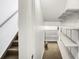 Unfinished basement featuring a staircase and storage shelves at 9102 W 107Th Pl, Broomfield, CO 80021