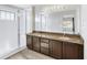 Bathroom features a double sink vanity, granite countertops, and separate glass door shower at 9102 W 107Th Pl, Broomfield, CO 80021