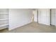 Spacious bedroom featuring built-in shelves, closet, and access to ensuite at 9102 W 107Th Pl, Broomfield, CO 80021