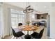 Bright dining area with a wooden table, modern chairs, and sliding doors that open to the patio at 9102 W 107Th Pl, Broomfield, CO 80021