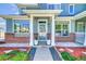 Inviting townhome exterior with brick accents, decorative planters, and beautiful landscaping at 9102 W 107Th Pl, Broomfield, CO 80021
