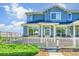 Charming blue townhome with white picket fence, lush green bush, and well-maintained landscaping at 9102 W 107Th Pl, Broomfield, CO 80021