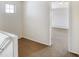 Hallway boasts neutral carpet, white walls, and natural light from a window and open doorway at 9102 W 107Th Pl, Broomfield, CO 80021