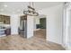 Open kitchen with stainless steel appliances, wood floors, and a view into the living room at 9102 W 107Th Pl, Broomfield, CO 80021