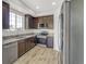 Modern kitchen with granite counters, stainless appliances, dark wood cabinetry, and bright natural light at 9102 W 107Th Pl, Broomfield, CO 80021
