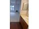 Bright bathroom with a spacious countertop and a view into the carpeted living area at 10650 E Tennessee Ave # 101, Aurora, CO 80012