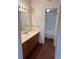 Bathroom with wood cabinets, spacious countertop and a view of a tiled shower/tub at 10650 E Tennessee Ave # 101, Aurora, CO 80012