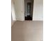 Carpeted bedroom leads to bathroom with tiled shower and closet with louvered doors at 10650 E Tennessee Ave # 101, Aurora, CO 80012