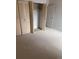 Bedroom showcasing closet and door, neutral carpet, and white walls at 10650 E Tennessee Ave # 101, Aurora, CO 80012