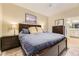 Comfortable bedroom with a dark wood bed frame, stylish pillows, and a matching nightstand at 7418 S Quail Cir # 1312, Littleton, CO 80127