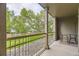 Private balcony offering outdoor seating and views of a green space at 7418 S Quail Cir, Littleton, CO 80127