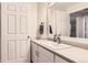 Bright bathroom with a clean vanity and door to the living room at 7418 S Quail Cir, Littleton, CO 80127