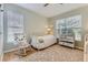 Cozy bedroom with rocking chair, single bed, and lots of natural light at 7418 S Quail Cir, Littleton, CO 80127