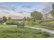 Picturesque community featuring a walking path, park bench, and a tranquil pond at 7418 S Quail Cir, Littleton, CO 80127