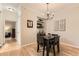 Stylish dining room with a modern chandelier, dark wood table, and decorative wall art at 7418 S Quail Cir, Littleton, CO 80127