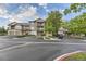 Inviting condo building with well-maintained landscaping and ample parking on a beautiful day at 7418 S Quail Cir, Littleton, CO 80127