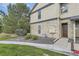 Charming condo exterior featuring stone accents, a well-kept lawn, and convenient access to the front door at 7418 S Quail Cir, Littleton, CO 80127