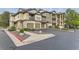Attractive condo building with stone accents, garages and well-kept landscaping in a parking area at 7418 S Quail Cir, Littleton, CO 80127
