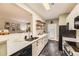 Modern kitchen featuring white cabinets, marble countertops, stainless steel appliances, and open layout at 7418 S Quail Cir, Littleton, CO 80127