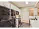 Modern kitchen with white cabinetry, stainless steel appliances, and a sleek black refrigerator at 7418 S Quail Cir, Littleton, CO 80127