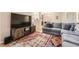 Spacious living room featuring a large television, hardwood floors, comfortable sofa, and an open layout at 7418 S Quail Cir, Littleton, CO 80127
