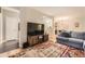 Inviting living room offering a large television, hardwood floors, comfortable sofa, and open-concept design at 7418 S Quail Cir, Littleton, CO 80127
