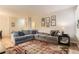 Comfortable living room showcasing a large sectional sofa, stylish decor, and hardwood flooring at 7418 S Quail Cir, Littleton, CO 80127