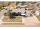Aerial view of the two story home with large front yard and driveway at 7845 Conifer Rd, Denver, CO 80221