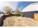 View of the backyard with partially fenced yard and the side of the home at 7845 Conifer Rd, Denver, CO 80221