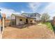 Backyard view of the two story home showing an outdoor stairway and parking area at 7845 Conifer Rd, Denver, CO 80221