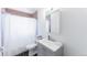 Well-lit bathroom featuring a modern vanity, a large mirror, and a shower with a white curtain at 7845 Conifer Rd, Denver, CO 80221