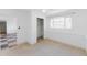 Bright bedroom features a large window, closet with shelving, and neutral carpet flooring at 7845 Conifer Rd, Denver, CO 80221