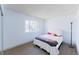 Cozy bedroom with a comfortable bed, soft carpet, a large window, and plenty of natural light at 7845 Conifer Rd, Denver, CO 80221