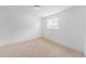 A well-lit bedroom is brightened by a window and features neutral carpet flooring at 7845 Conifer Rd, Denver, CO 80221