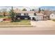 A charming two-story home featuring a black and white exterior, a two-car garage, and a well-maintained lawn at 7845 Conifer Rd, Denver, CO 80221
