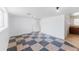 A spacious living room with checkered floors and white walls features natural light from the window at 7845 Conifer Rd, Denver, CO 80221