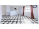 Spacious living room showcasing distinctive monochrome checkered floors, and neutral wall color scheme at 7845 Conifer Rd, Denver, CO 80221