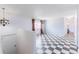 Bright living room with monochrome checkered floors and a large window with lots of natural light at 7845 Conifer Rd, Denver, CO 80221