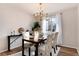 Elegant dining room with hardwood floors, modern chandelier, and neutral decor and natural lighting at 1494 S Yampa Ct, Aurora, CO 80017