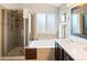 Bright bathroom featuring a glass enclosed shower and separate soaking tub at 17127 Yellow Rose Way, Parker, CO 80134