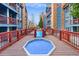 Covered hot tub on a deck between building wings at 100 S Park Ave # E312, Breckenridge, CO 80424